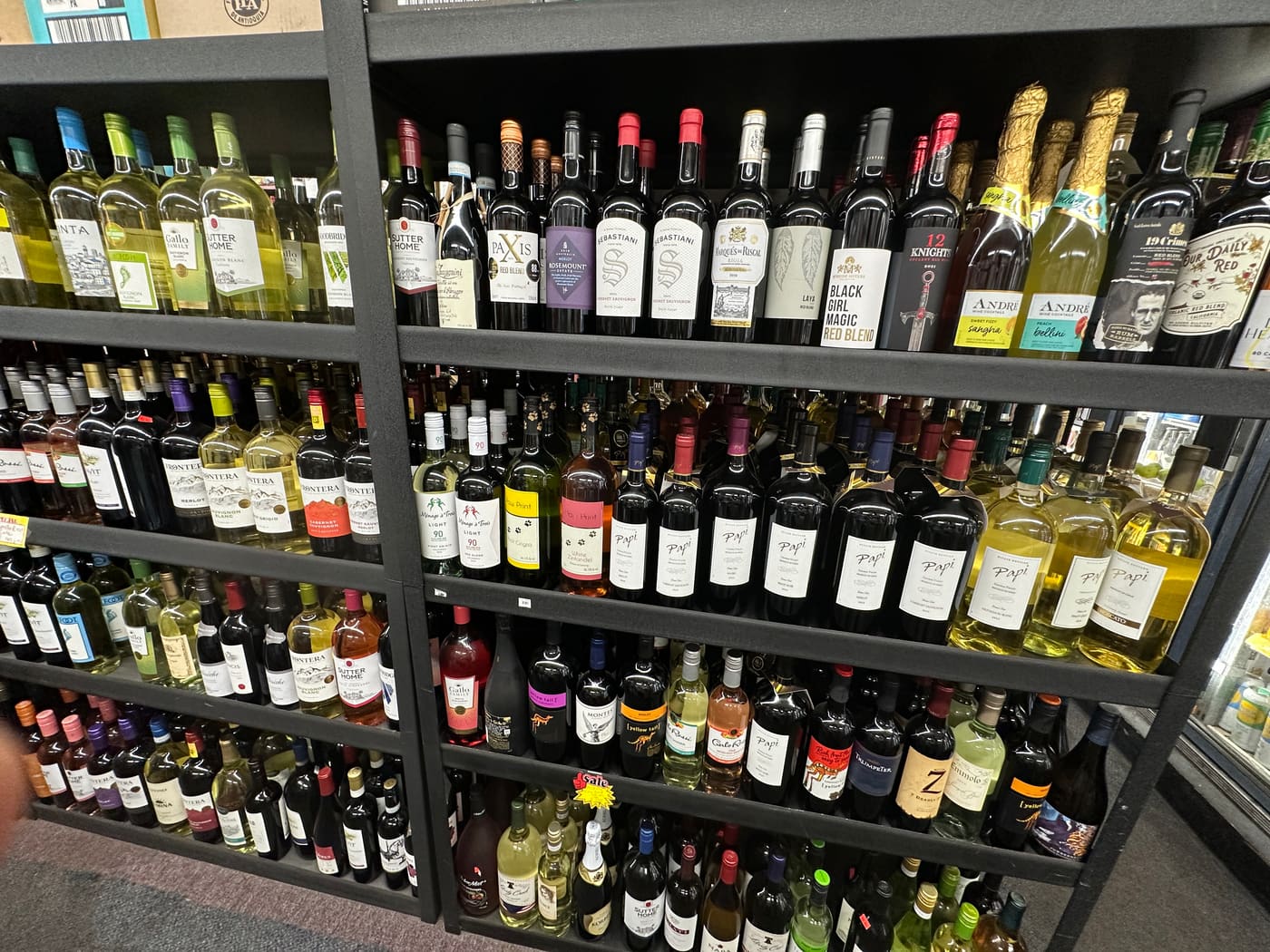 Floor-to-ceiling shelving on Te-Amo's wine wall, filled with bottles across reds, whites and rosés.